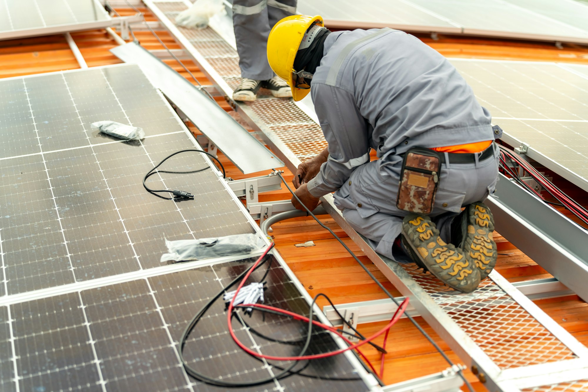 Engineer service check installation solar cell on the roof of factory.